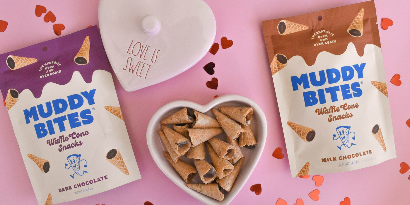 Valentine’s-themed heart-shaped box containing Muddy Bites with a pink background